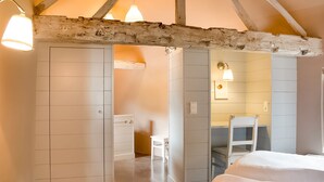 A bedroom with a wooden ceiling, a bed, a chair, and a desk. - Getaway With Sauna in Falaen (Onhaye)
