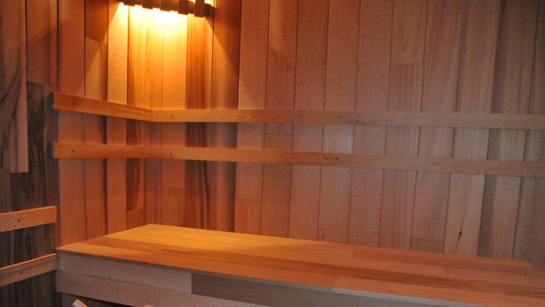 A sauna with wooden walls and benches.