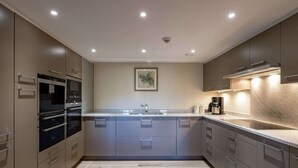 A modern kitchen with built-in appliances, a central island, and a stainless steel sink. - Cozy Holiday Home in Gedinne near Forest (Gedinne)
