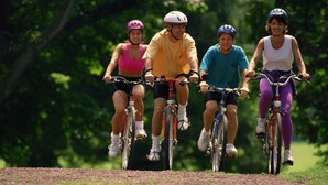 Four people riding bicycles on a dirt path surrounded by greenery. - Holiday Home in Houffalize With Valley Views (Houffalize)