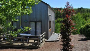 A rustic wooden building with a deck and outdoor seating area. - Holiday Home in Houffalize With Valley Views (Houffalize)