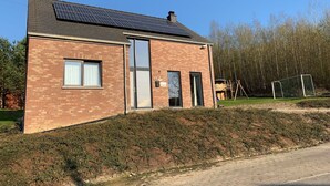 A two-story brick building with a solar panel roof, a door, and a window. - Holiday Home in Barvaux With Sauna & Garden (Durbuy)