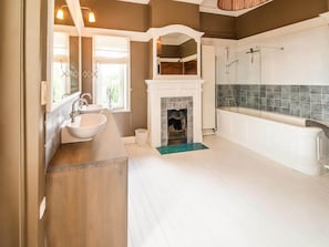 A spacious bathroom with a large sink, a fireplace, and a bathtub. - Impressive Castle in Spa With a Swimming Pool (Jalhay)