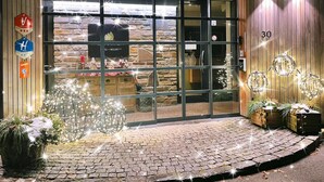 A hotel entrance with a stone facade, a sign indicating 'Hotel & Resort', and a number '30' on the wall. - Cottage Famille - Family Resort With Wellness in the Heart of the Ardennes (Malmedy)