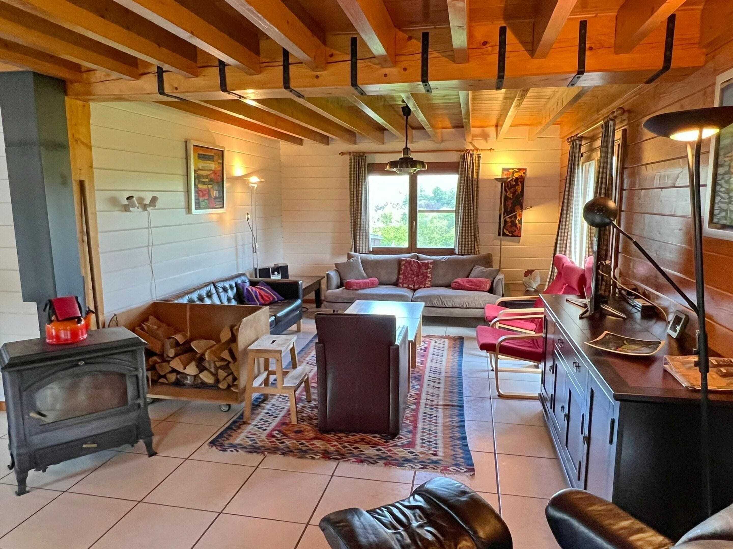 Ein gemütliches Wohnzimmer mit Kamin, einer Couch und einem Essbereich.