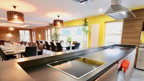 A modern restaurant with a long counter, multiple tables, and chairs. - Holiday Home in Stoumont With Private Sauna (Stoumont)