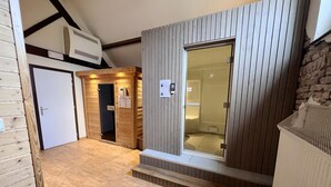 A compact room with a wooden floor, a bed, a small table, and a shower area. - House near Caves of Hotton, L' Ourthe, & Durbuy (Somme-Leuze)