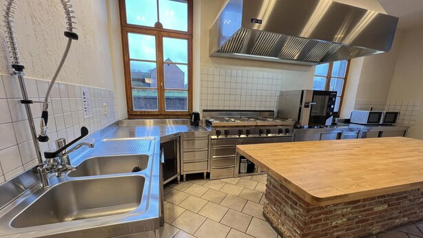 A modern kitchen with stainless steel appliances, a large island, and a window with a view. - House near Caves of Hotton, L' Ourthe, & Durbuy (Somme-Leuze)
