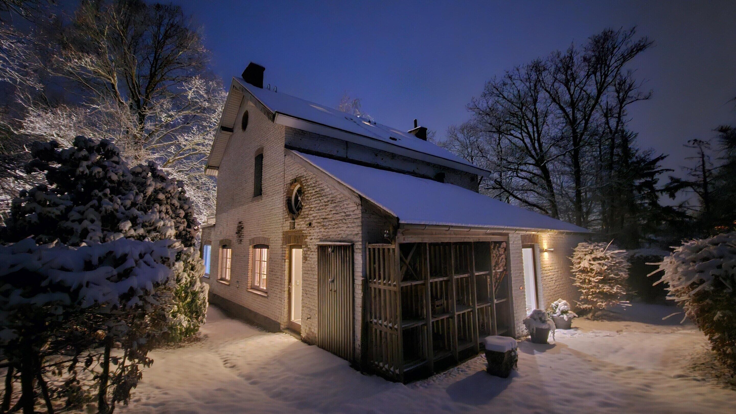 A two-story house with a snow-covered roof and a garage.