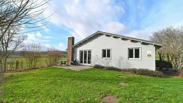 Enjoy outdoor dining or relaxation on the patio surrounded by a well-maintained lawn.