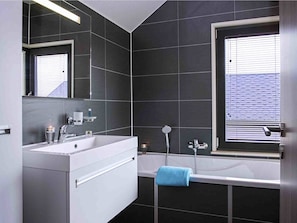 Villa | Bathroom | Bathtub, hair dryer, towels