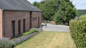 A brick building with a paved driveway and a hedge. - Villa in Belgium With Private Pool & Garden (Gesves)