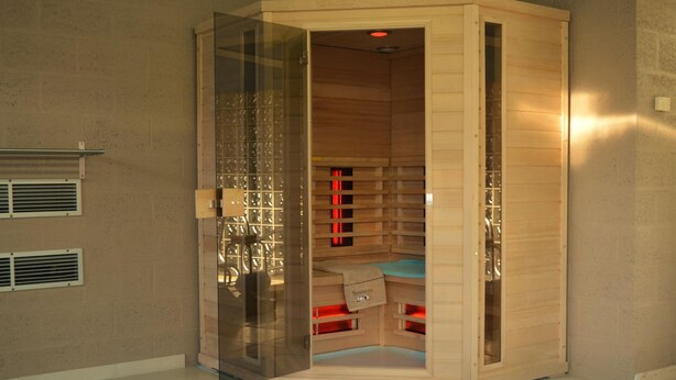 A sauna with a glass door, wooden interior, and a towel on the floor. - Villa in Belgium With Private Pool & Garden (Gesves)