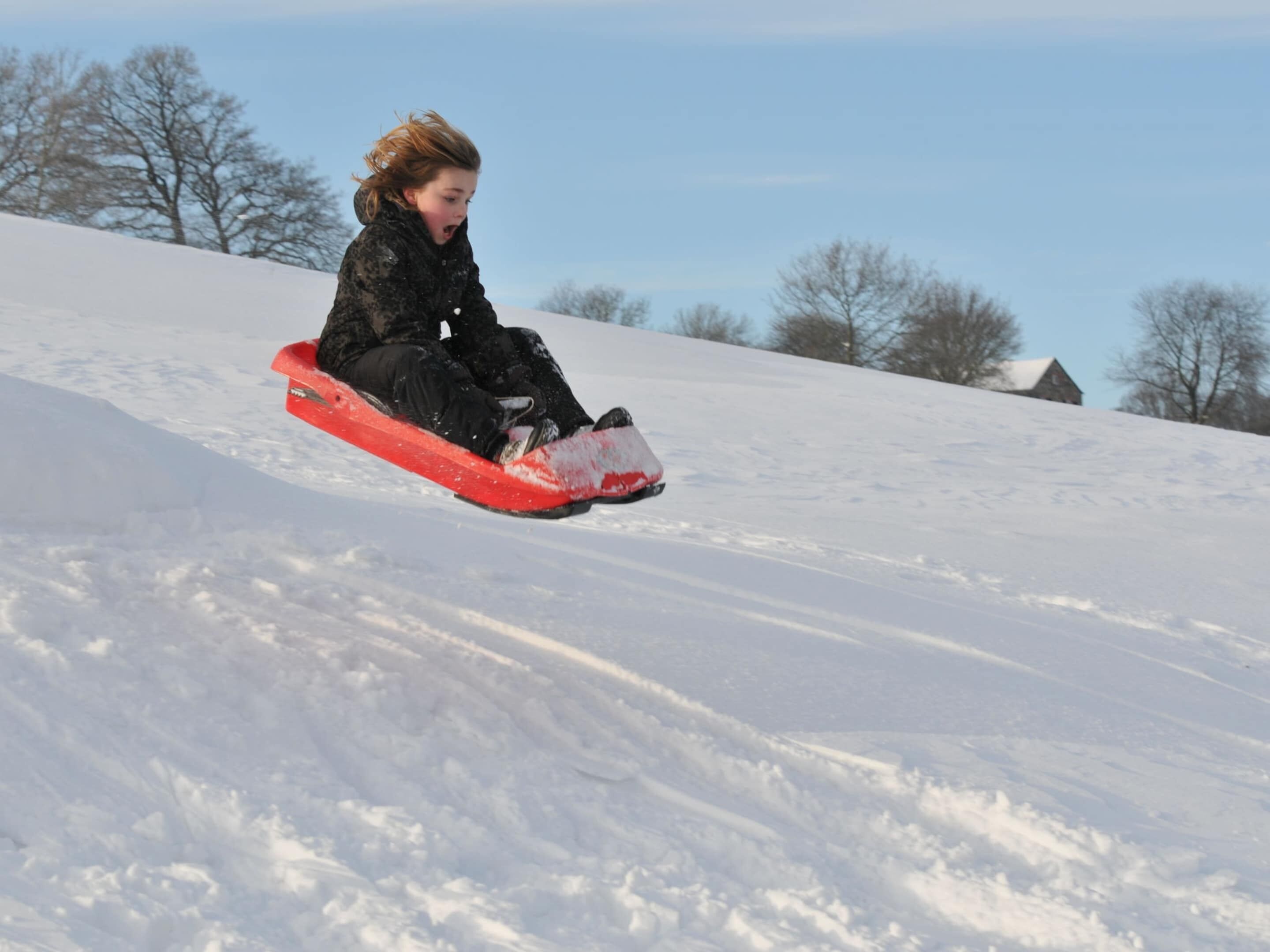 A person snowboarding down a snowy slope.