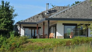 A modern house with a stone roof, large windows, and a covered patio area. - House in Somme-leuze Near Ardennes Hills (Somme-Leuze)