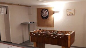 A room with a foosball table, a dartboard, and an ice hockey rink. - Beautiful Holiday Home in Malmedy-beverce With Sauna (Malmedy)