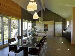 A modern kitchen with a central island, stainless steel appliances, and a view of the outdoors. - Holiday Home in Stoumont With Valley View (Stoumont)