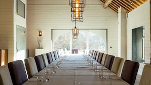 A long dining table with chairs, a chandelier, and a view of trees through large windows. - Cozy Holiday Home in Gedinne near Forest (Gedinne)