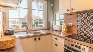 Une cuisine moderne équipée d’un évier, d’un grille-pain, d’une bouilloire et d’un four.