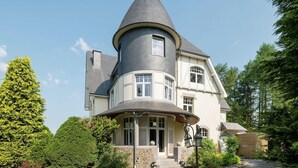 A large, multi-story house with a distinctive turret and a wrap-around porch. - Chateau in Stavelot With Private Pool & Sauna (Stavelot)