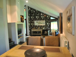 Relax in this stylish living space with a sofa, armchairs, and a dining table.