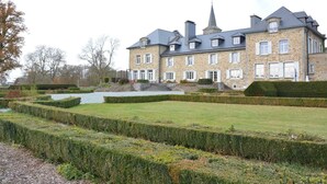 A large stone building with multiple windows and a central tower. - Castle in Ardennes Near Forest & Sauna (Libramont-Chevigny)
