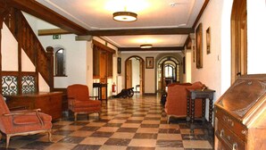 A lobby with checkered flooring, wooden furniture, and a staircase. - Castle in Ardennes Near Forest & Sauna (Libramont-Chevigny)