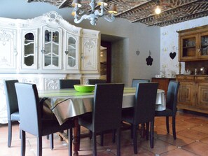 A dining area with a white ornate cabinet, a chandelier, and a tiled floor. - Champlon Villa Near Forest (Tenneville)