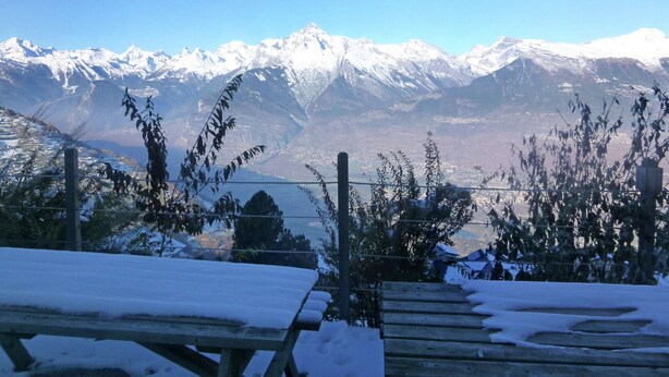 A snow-covered picnic table with a mountain view in the background. - Chalet for 6 People With Views of Veysonnaz (Veysonnaz)