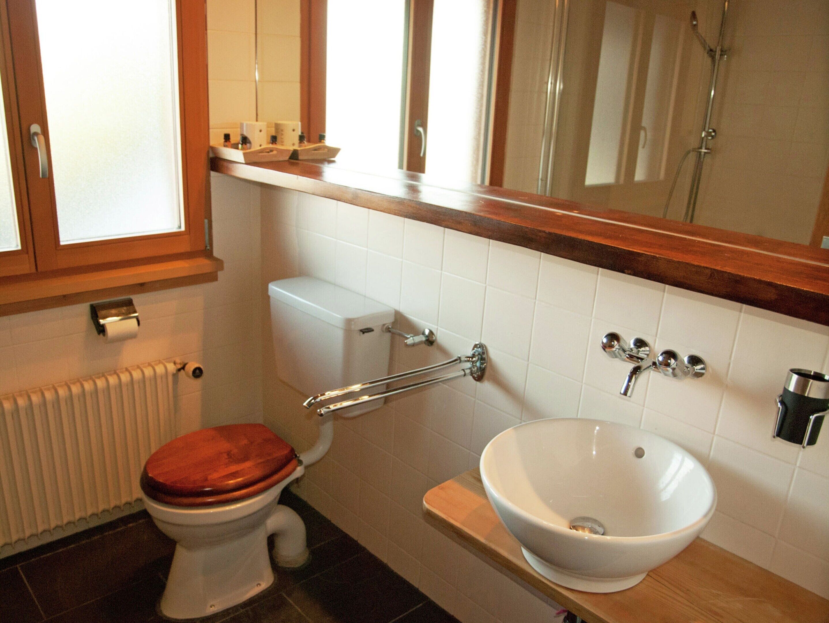 A bathroom with a toilet, a sink, and a shower.
