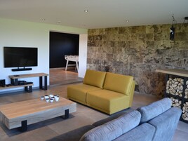 A modern living room with a sofa, coffee table, and television.