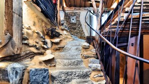 A stone staircase with a metal railing leading to a wooden door. - Farmhouse in Durbuy With Sauna & Garden (Durbuy)