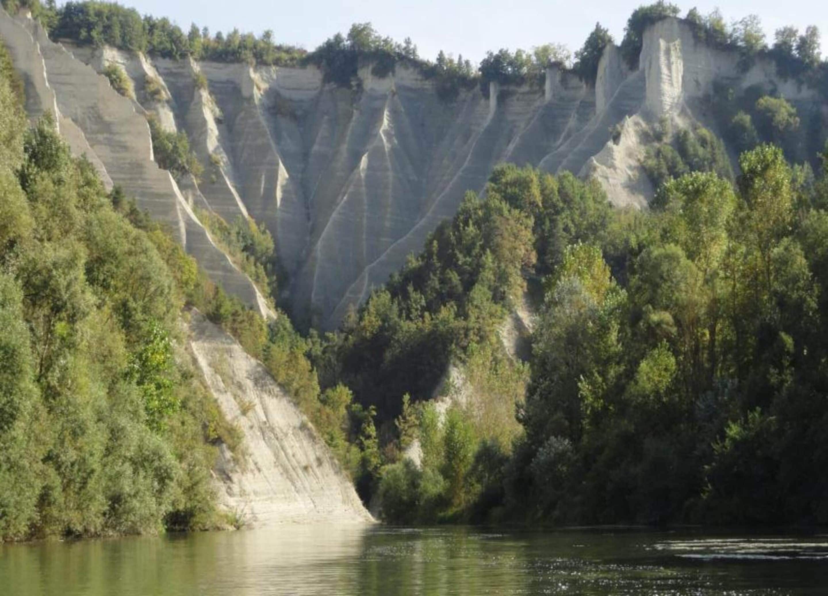 A river canyon with steep cliffs and dense vegetation.