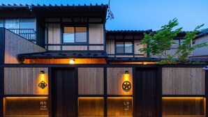 A traditional Japanese building with wooden exterior and illuminated panels.