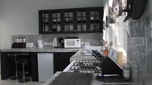 Deluxe Apartment | Shared kitchen facilities | Fridge, microwave, oven, electric kettle - Brimstone View Guest Apartments (Old Road Town)