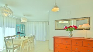 A dining area with a table and chairs, a blue cabinet, and a red dresser with drawers. - Peaceful Villa in Sveti Lovrec With Swimming Pool (Sveti Lovrec)