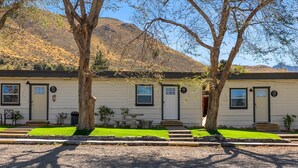 A row of white mobile homes with numbered doors, set against a backdrop of hills. - WWM 3 · 3 Explore, Swim, Dream, The E Sierras WWM 3 (Coleville)