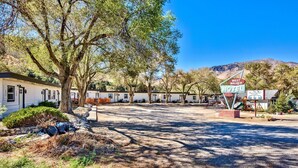 A motel with a signboard, trees, and a clear sky. - WWM 3 · 3 Explore, Swim, Dream, The E Sierras WWM 3 (Coleville)