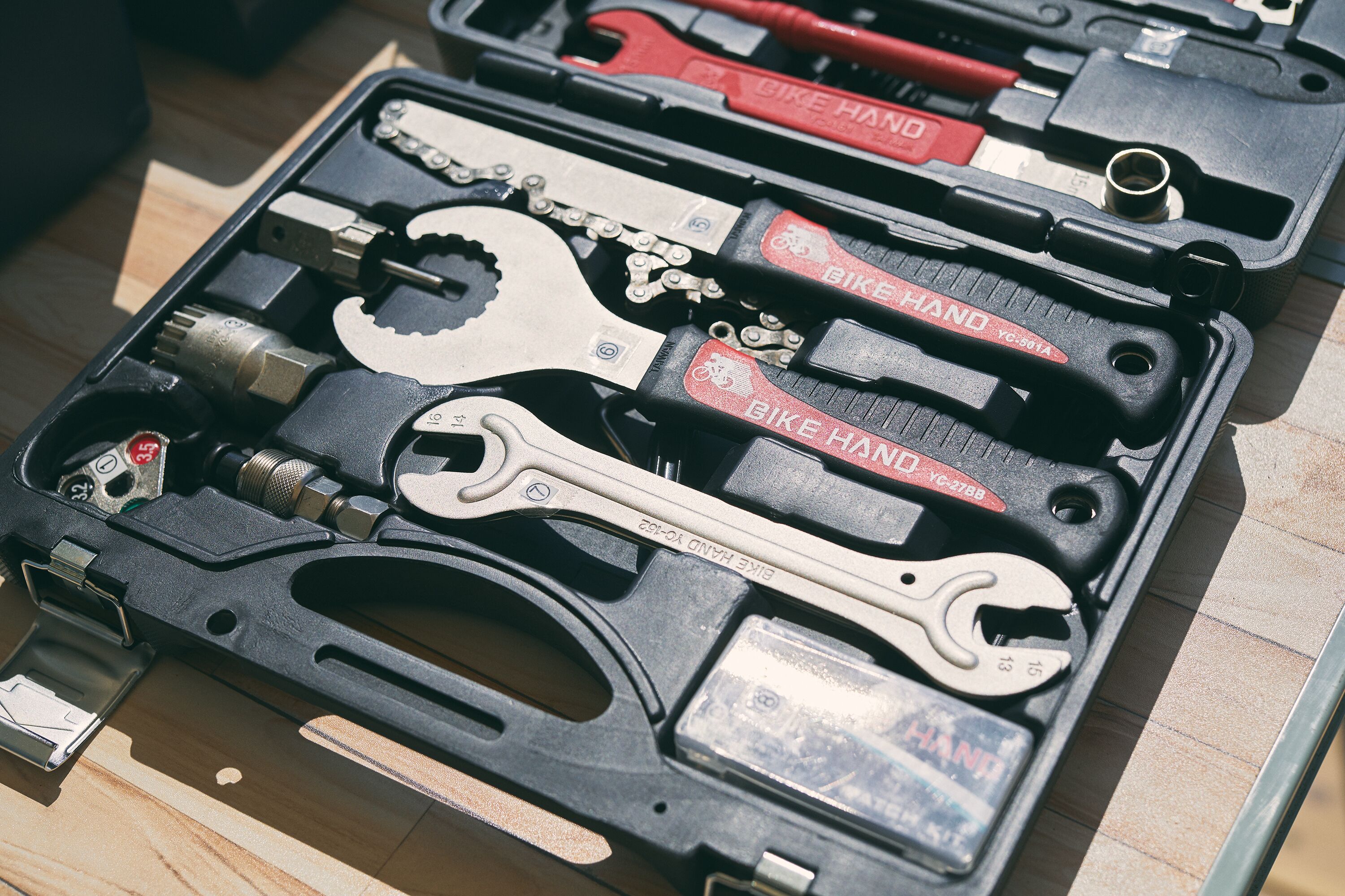 A bike tool kit with various tools including wrenches and a chain tool.