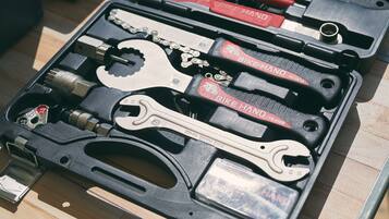 A bike tool kit with various tools including wrenches and a chain tool.