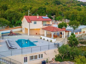 A two-story house with a swimming pool, outdoor seating, and a red-roofed pavilion. - Brand new Countryside Villa With Heated Pool (Omis)