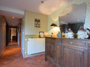 A hallway with a radiator, wooden cabinets, and a mirror. - Renovated Mill in Bastogne Near Waterfall (Bastogne)