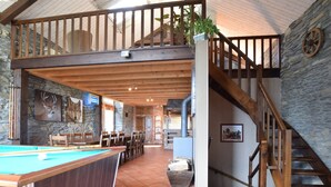 A spacious indoor area with a pool table, wooden furniture, stone walls, and a staircase leading to an upper level. - Renovated Mill in Bastogne Near Waterfall (Bastogne)