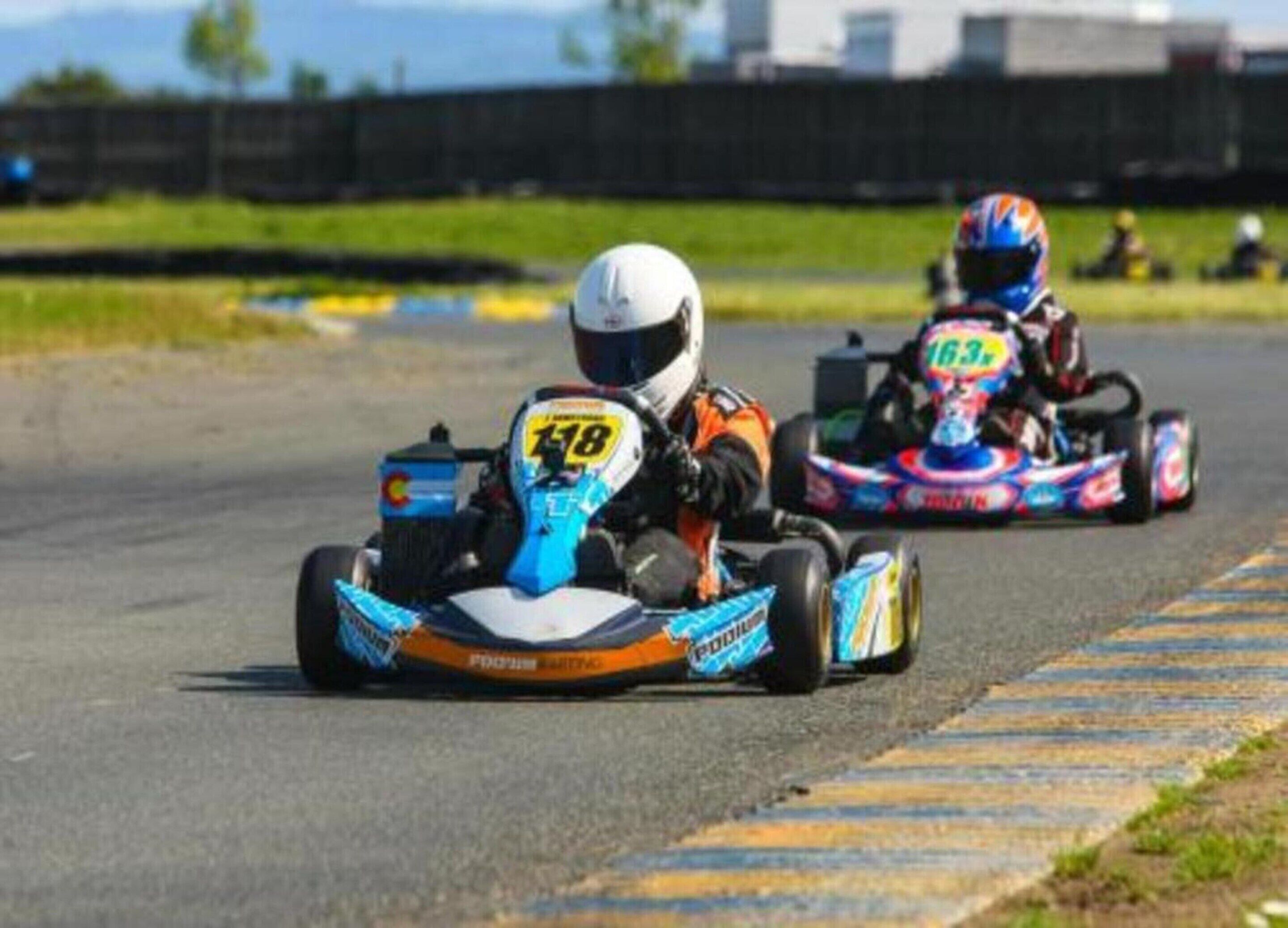 A go-kart race on a track with two karts, one with the number 118 and another with the number 163.