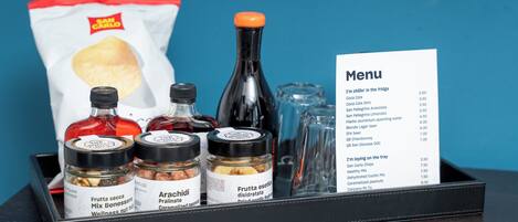 A tray with snacks, condiments, and a menu.