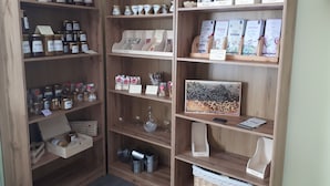 Une étagère en bois contenant divers objets, notamment des bocaux, des boîtes et des livres.