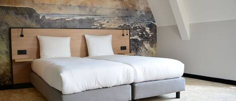 Une chambre à coucher moderne avec un grand lit, une tête de lit dotée d’un éclairage intégré et un mur décoré d’une fresque à motifs.