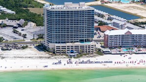 A high-rise hotel with multiple balconies, a beach, and a pool area. - BEAUTIFUL BEACHFRONT! 1 MILE W OF PIER PARK! (Panama City Beach)