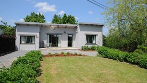 A modern two-story building with a flat roof, large windows, and a small front porch. - Holiday Home in Noiseux With Private Hot Tub (Somme-Leuze)