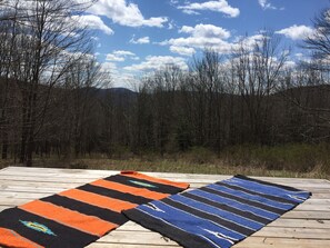 Surrounded by a lush forest and mountain views, this deck offers a serene outdoor space.